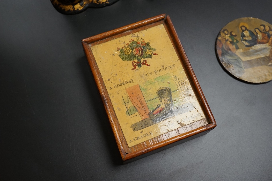 A Victorian Papier mache japanned sewing box, stamped ‘Lane, Birmingham’, the cover with a view of Chingford old church Essex, a boxed Victorian French translation game, by E C Spurin and a papier mache panel (3)